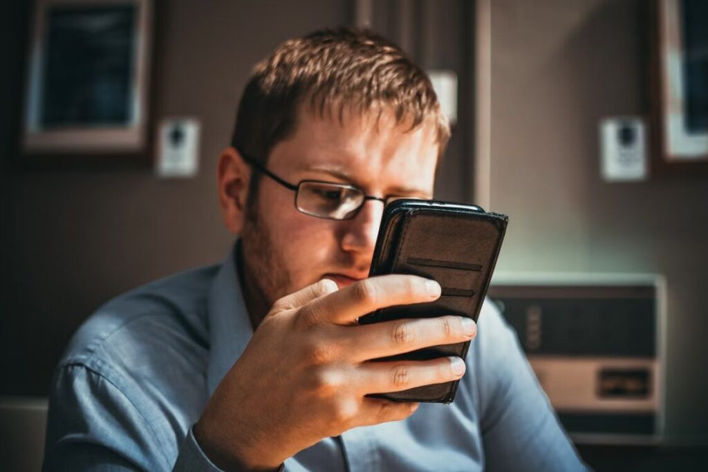 Person reading digital comics on a smartphone through a mobile reading app.